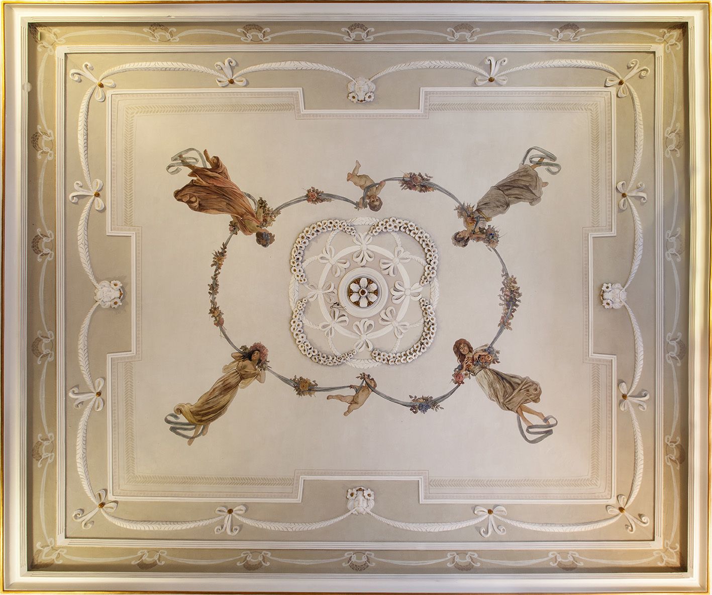 A ceiling with ornate floral and geometric patterns, framed by a gold border.