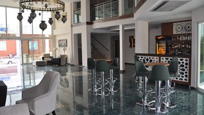 A lobby with a bar area, seating, and a staircase. - Malahit Exclusive City Hotel (Fethiye)