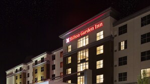 A multi-story hotel with a prominent "Hilton Garden Inn" sign.