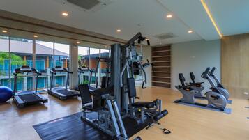 A gym with treadmills, elliptical machines, and weight equipment.