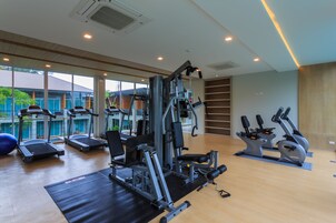 A gym with treadmills, elliptical machines, and weight equipment.