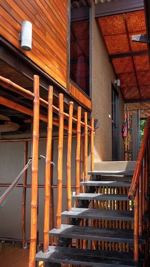 A wooden staircase with a bamboo railing, leading to a covered entrance area. - Alama Sea Village Resort (Ko Lanta)