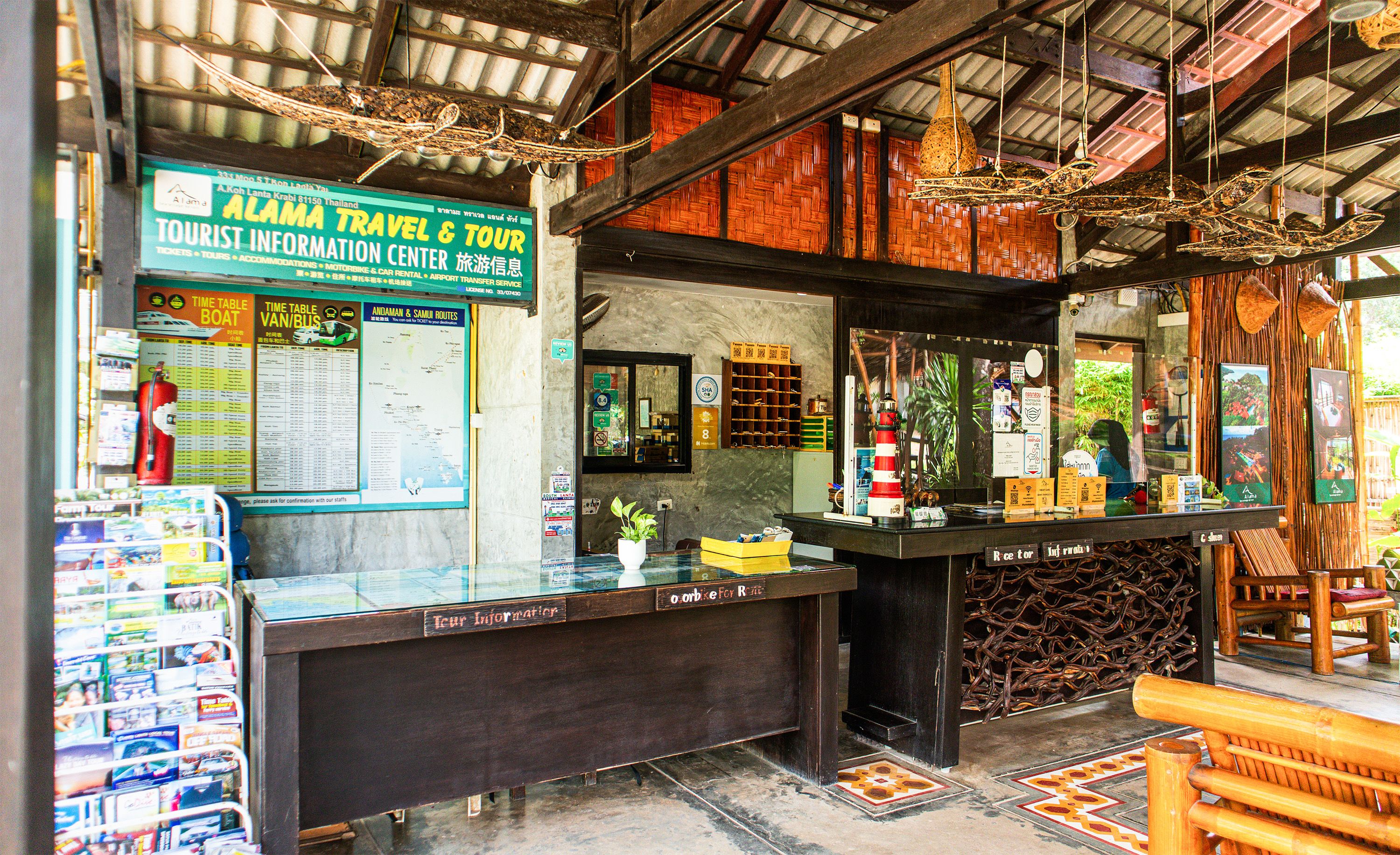 A tourist information center with a wooden interior, information boards, and a counter with various items.