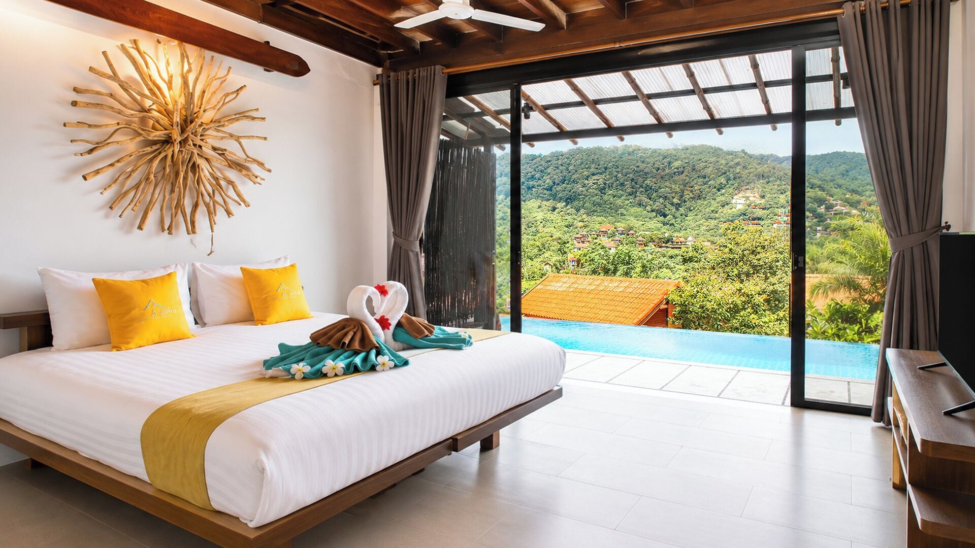 A bedroom with a large bed, a view of a lush landscape, and a ceiling fan.
