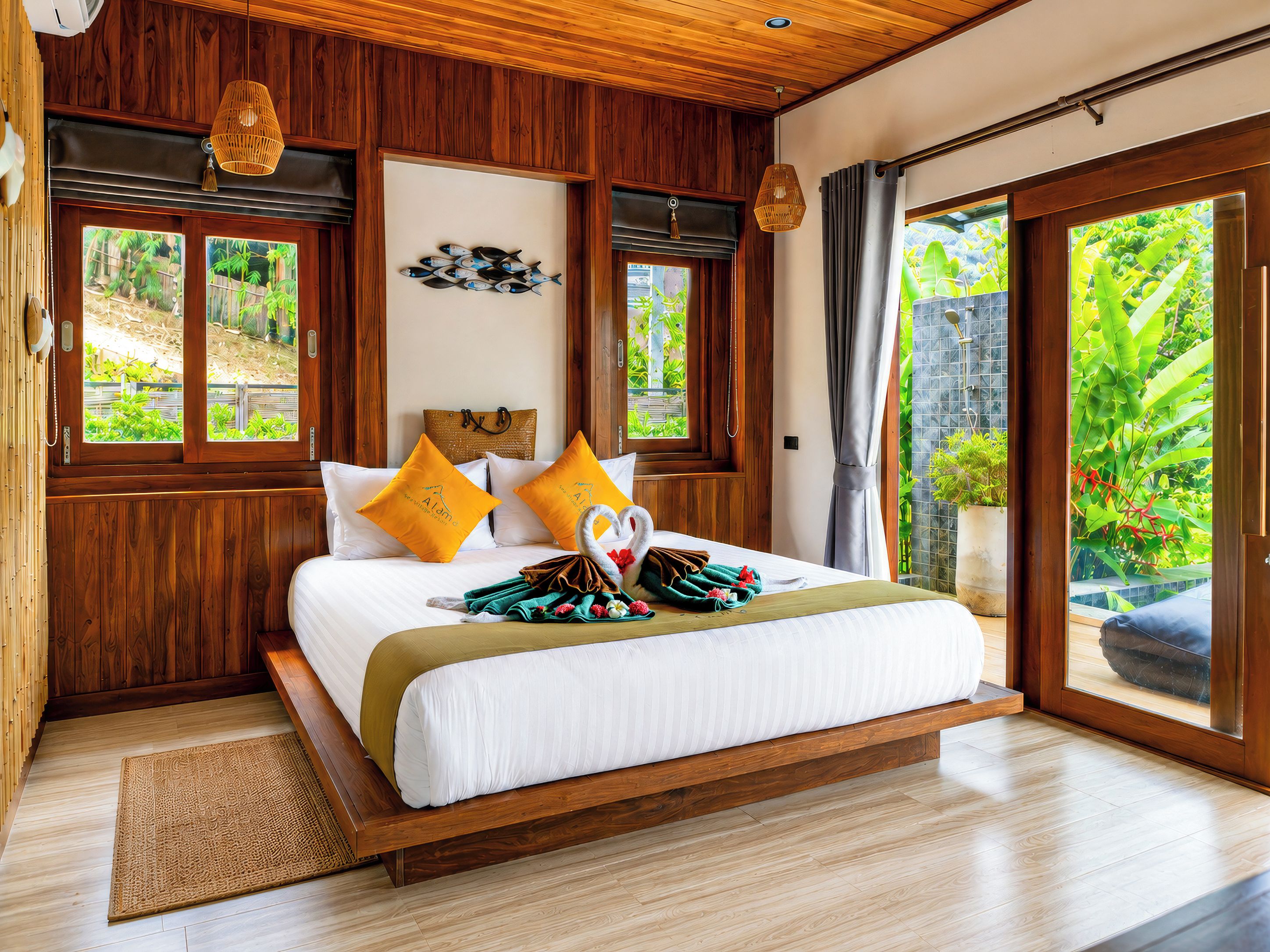 A wooden-framed bedroom with a bed, two pillows, a wall-mounted artwork, and a view of greenery through the window.