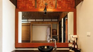 A bathroom with a wooden vanity, a sink, and a mirror. - Alama Sea Village Resort (Ko Lanta)
