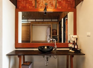 A bathroom with a wooden vanity, a sink, and a mirror. - Alama Sea Village Resort (Ko Lanta)