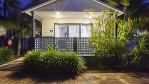 A house with a covered porch, a fenced front yard, and a sign indicating the address. - Discovery Parks - West Busselton (West Busselton)