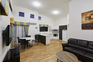 A modern apartment with a dining area, kitchen, and living room. - Discovery Parks - West Busselton (West Busselton)