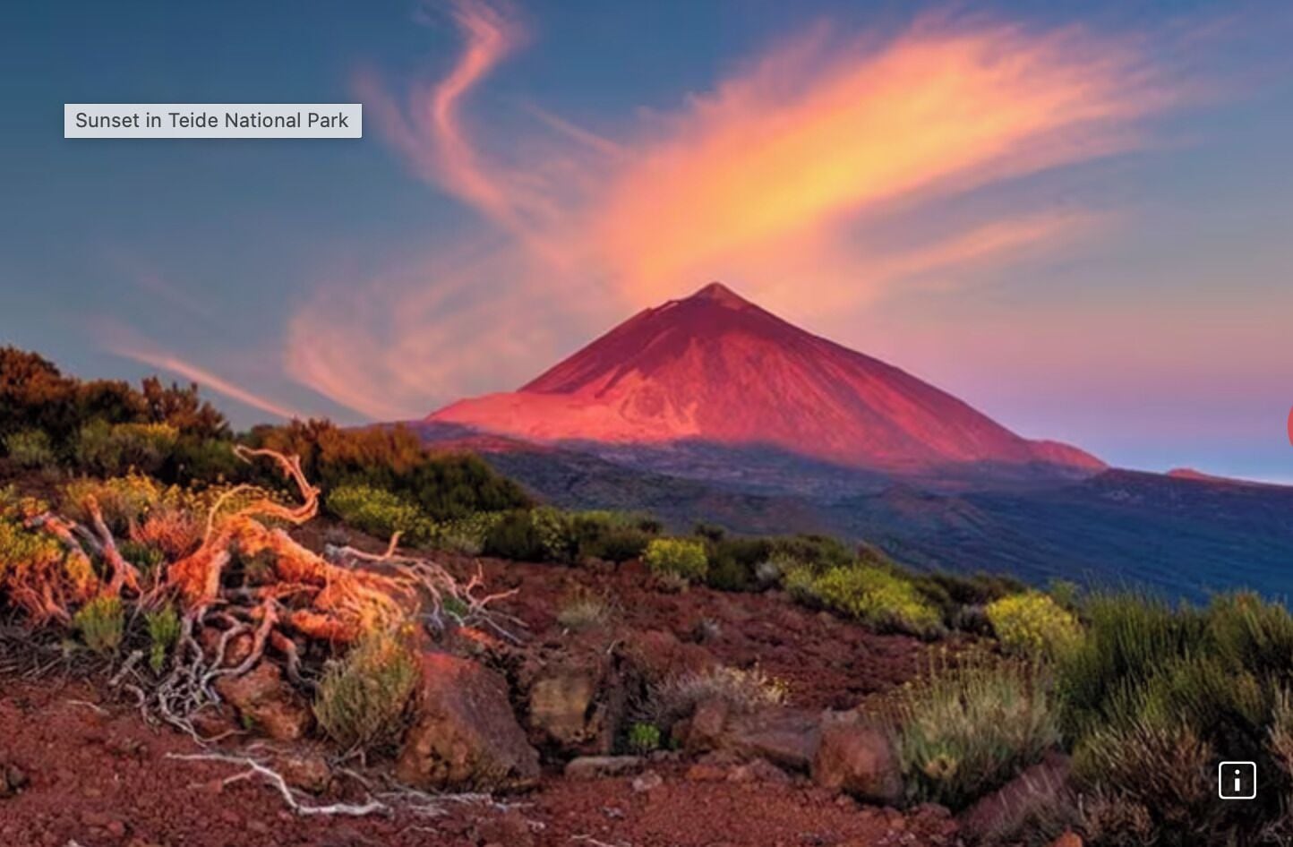 A sunset in Teide National Park with a prominent mountain in the background.