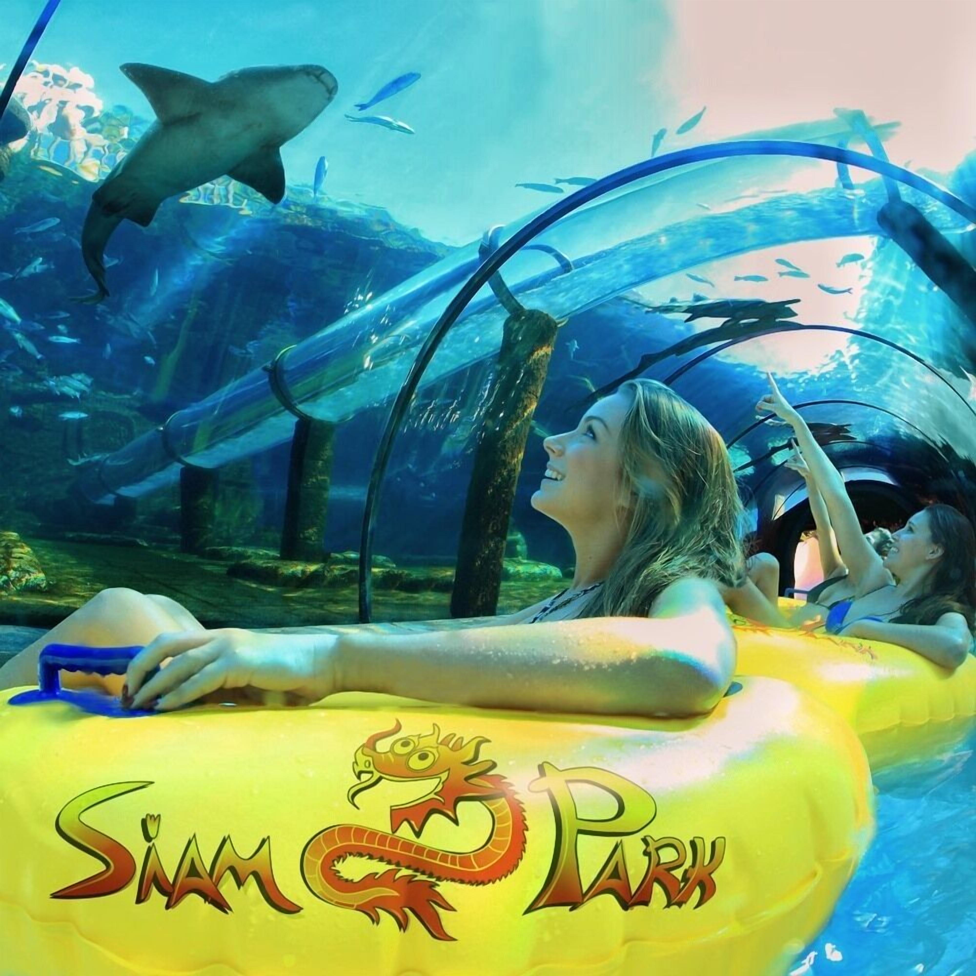An aquarium with a glass tunnel, sharks, and a sign reading "Siam Park".