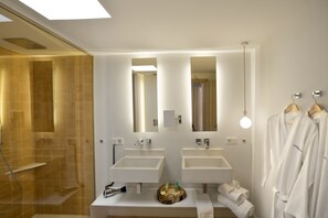Shower, designer toiletries, hair dryer, bathrobes
