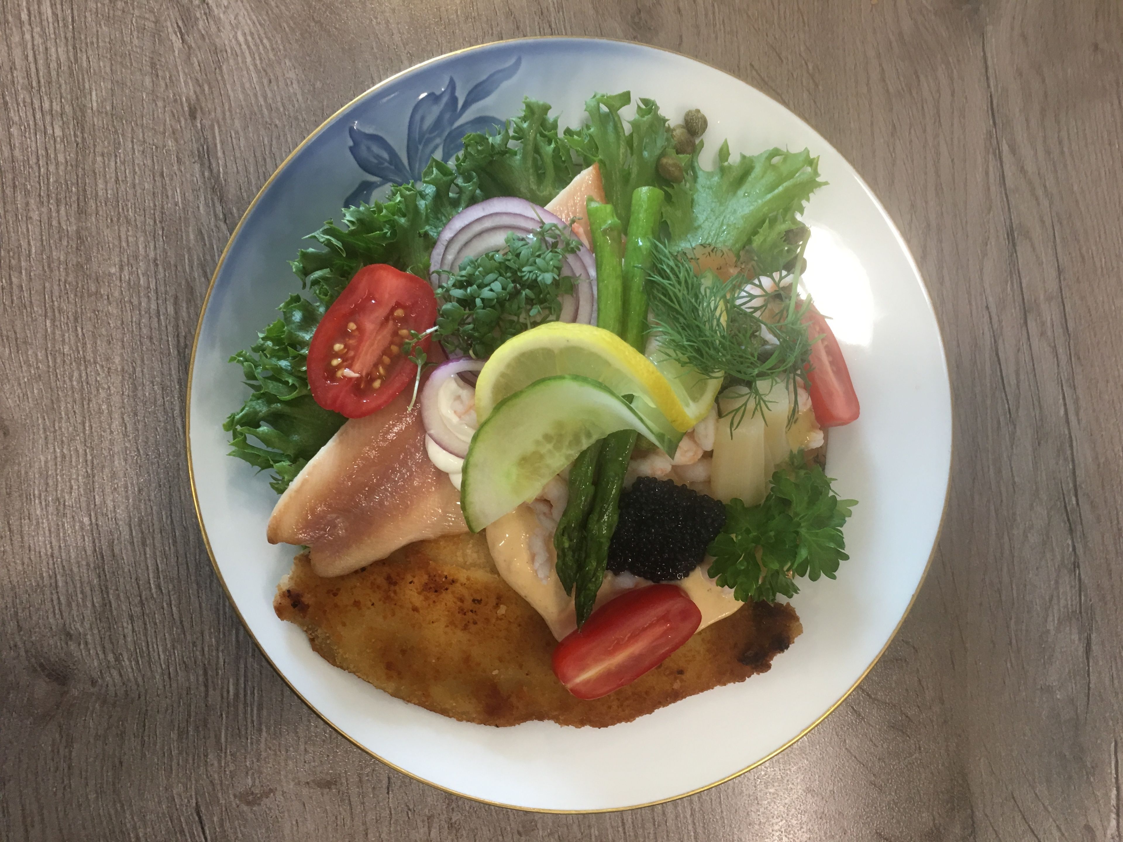 A plate of food with a variety of vegetables and a piece of meat.