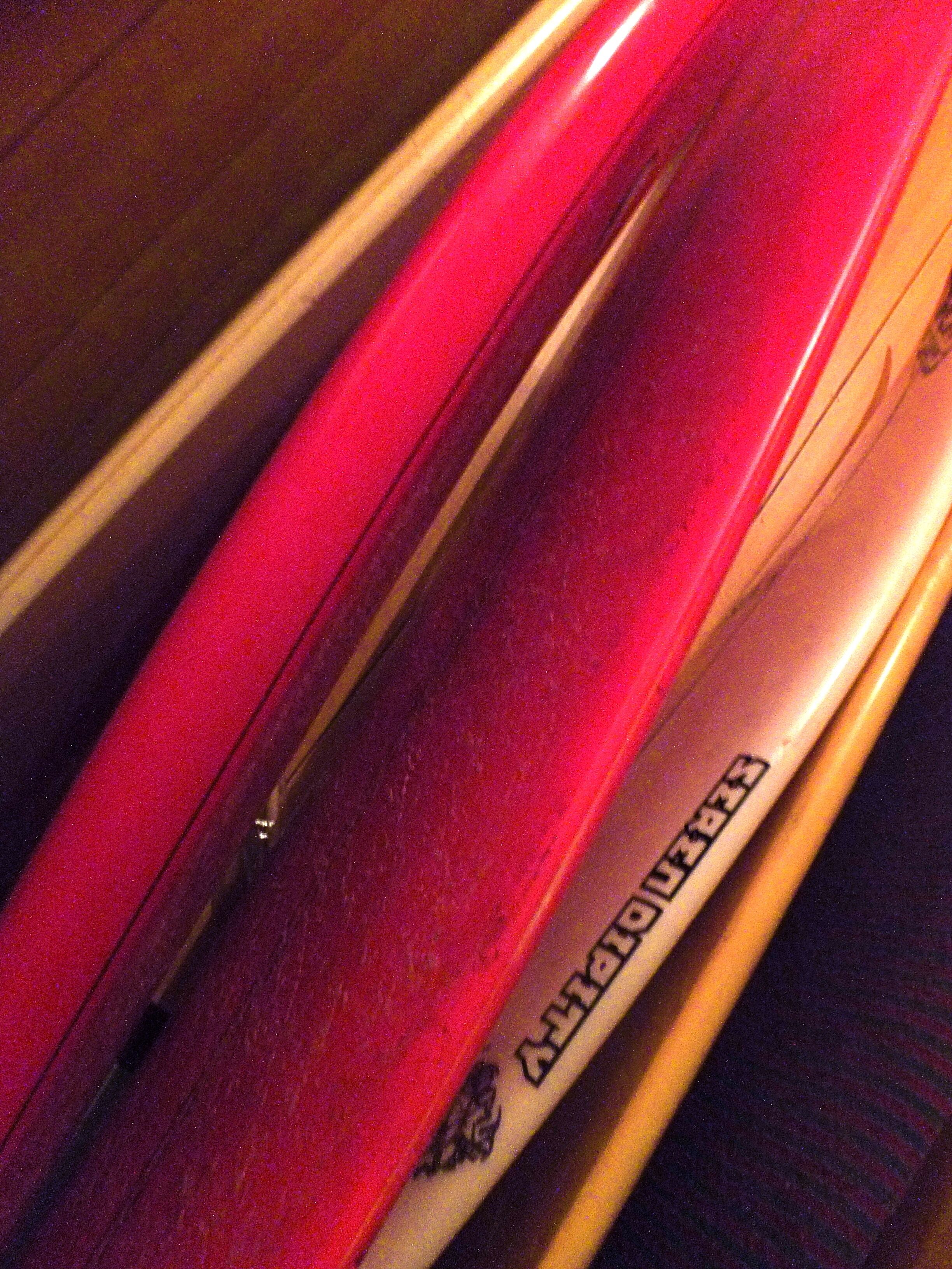 A close-up of a red and white ski with the brand name "FISCHER" visible on the side.