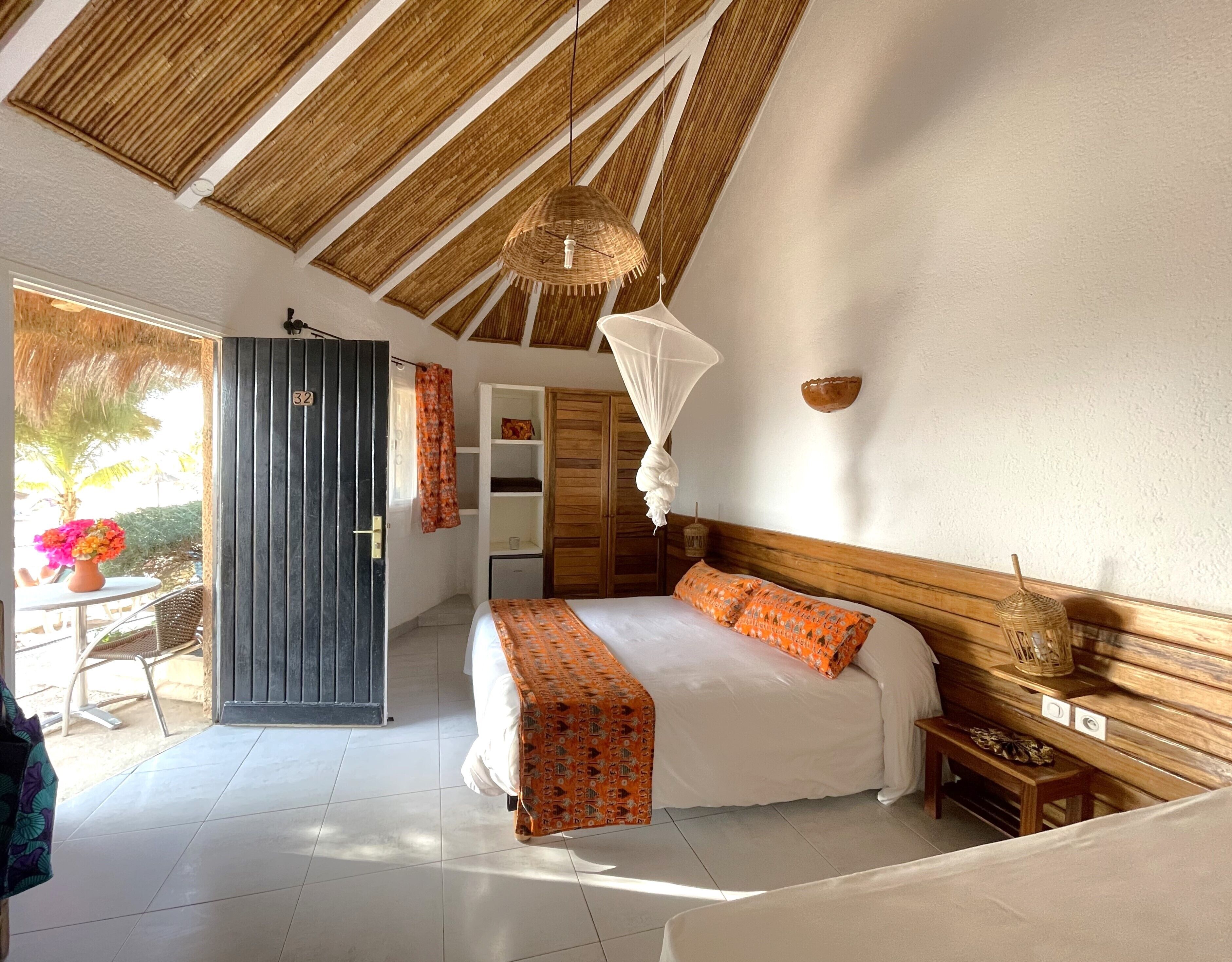 A bedroom with a bed, bedside table, and a wardrobe.