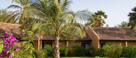 A building with a sloped roof and a well-maintained lawn.