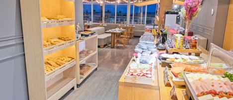 A buffet area with multiple food stations, wooden display cases, and seating arrangements.