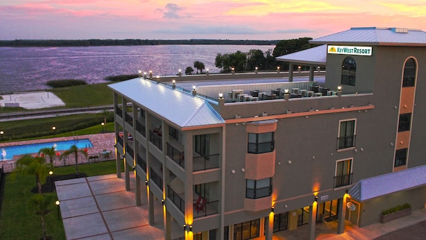 A hotel with a pool, a view of the water, and a sign for KeyWest Resort. - The Citrus on the Lake (Tavares)