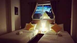 A hotel room with two single beds, a nightstand with a lamp, and a window with a view of a building. - Nap Box Hostel (Chiang Mai)