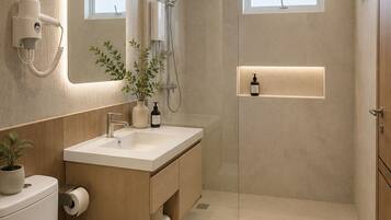 A modern bathroom with a glass-enclosed shower, a vanity with a mirror, and a toilet.