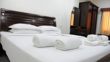 Premium bedding, desk, laptop workspace, rollaway beds