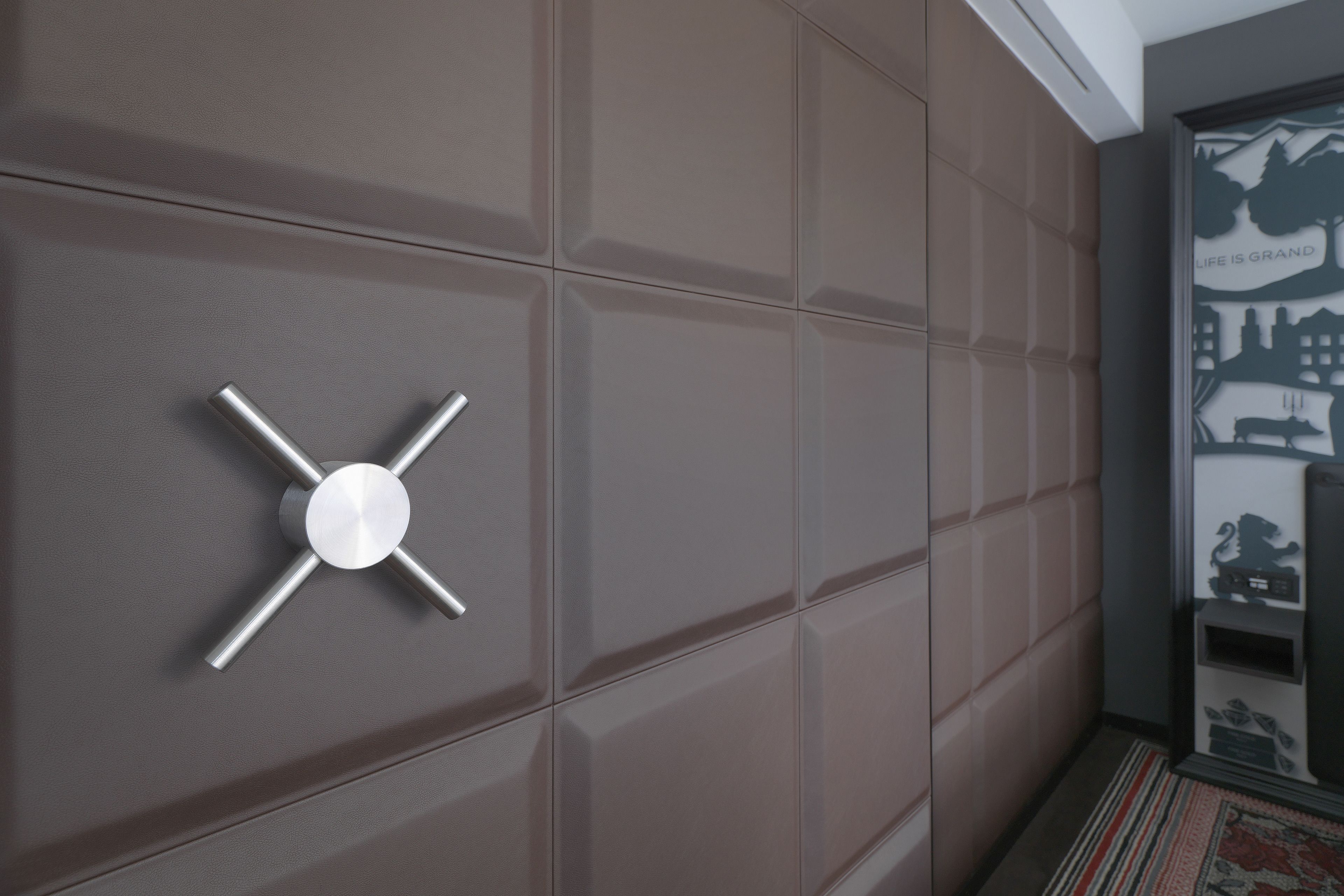 Ein modernes Interieur mit einem metallischen, kreuzförmigen Objekt an der Wand.
