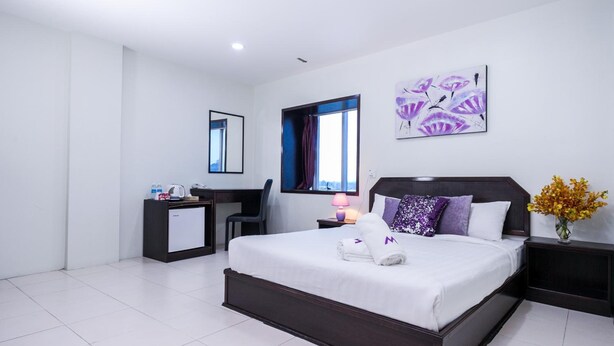 A modern hotel room with a large bed, a desk, a chair, a nightstand, and a window with curtains. - M2 Hotel Melaka (Malacca City)