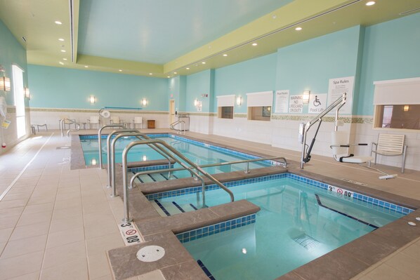 A swimming pool with multiple lanes, safety railings, and a lifeguard chair. - Holiday Inn Bismarck by IHG (Bismarck)