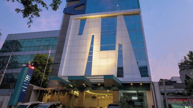 A modern hotel building with a prominent 'HOTEL 88' sign, large windows, and a well-lit entrance. - Hotel 88 Grogol by WH (Jakarta)