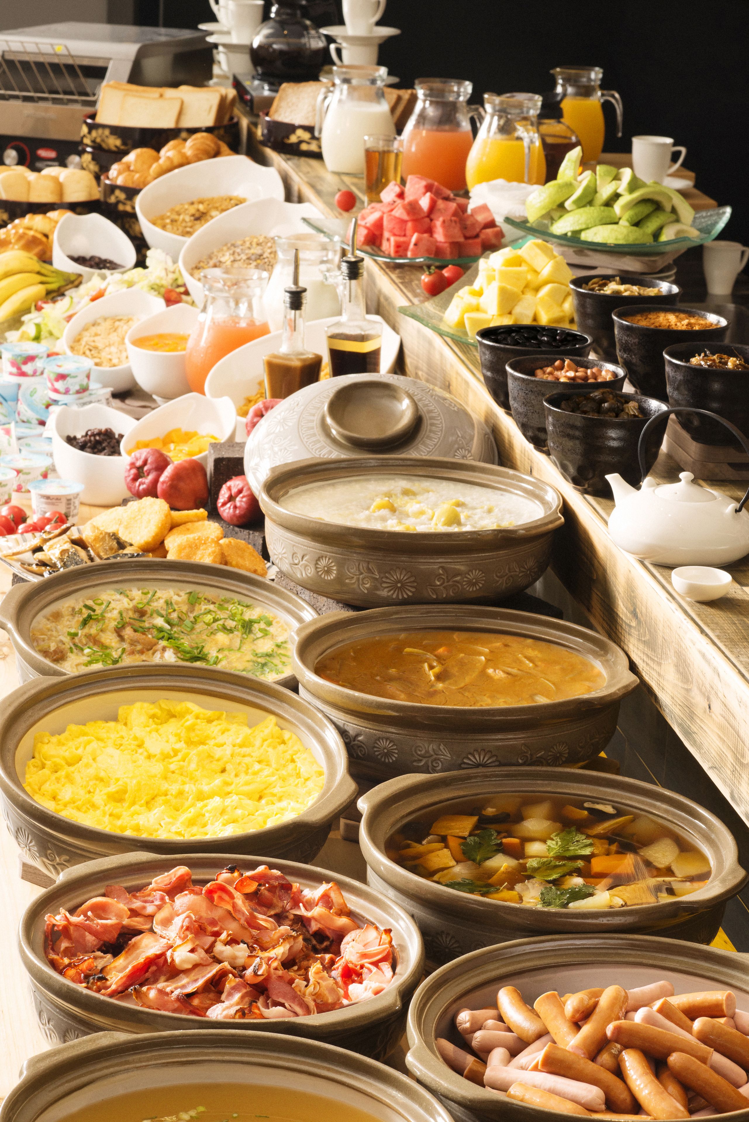 A buffet with various food items and beverages.