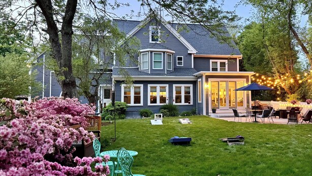 A house with a large backyard, a patio area with outdoor furniture, and a well-maintained lawn. - 3 Waves Bed & Breakfast (Plymouth)