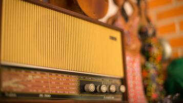 A vintage radio with a wooden frame and a dial.