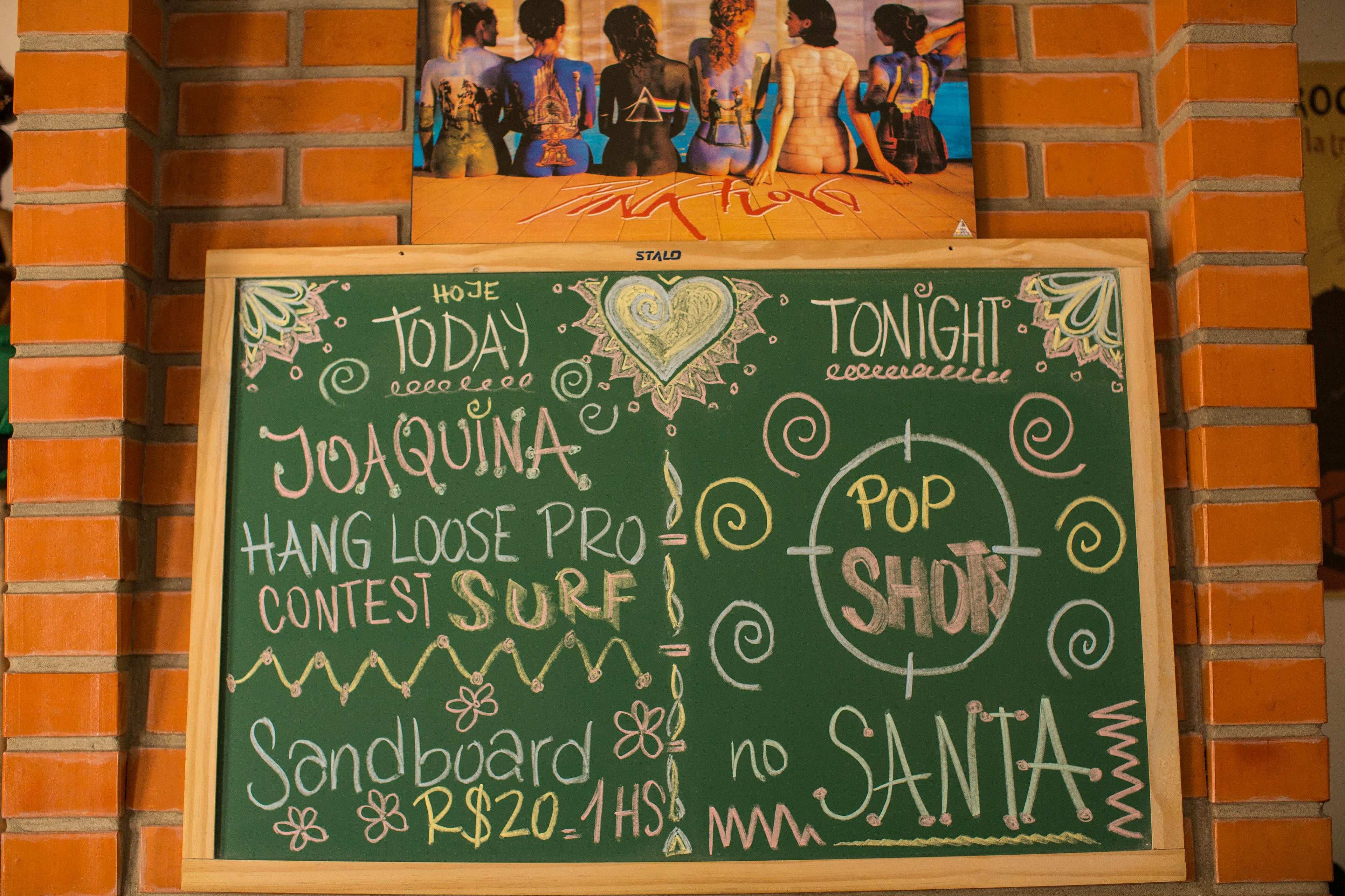 A chalkboard with event details including a contest, a price, and a mention of Santa.