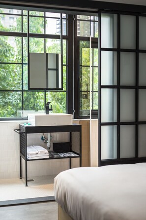 A modern bathroom with a large window, a sink, and a mirror. - Art'otel Ximending Taipei (Taipei)