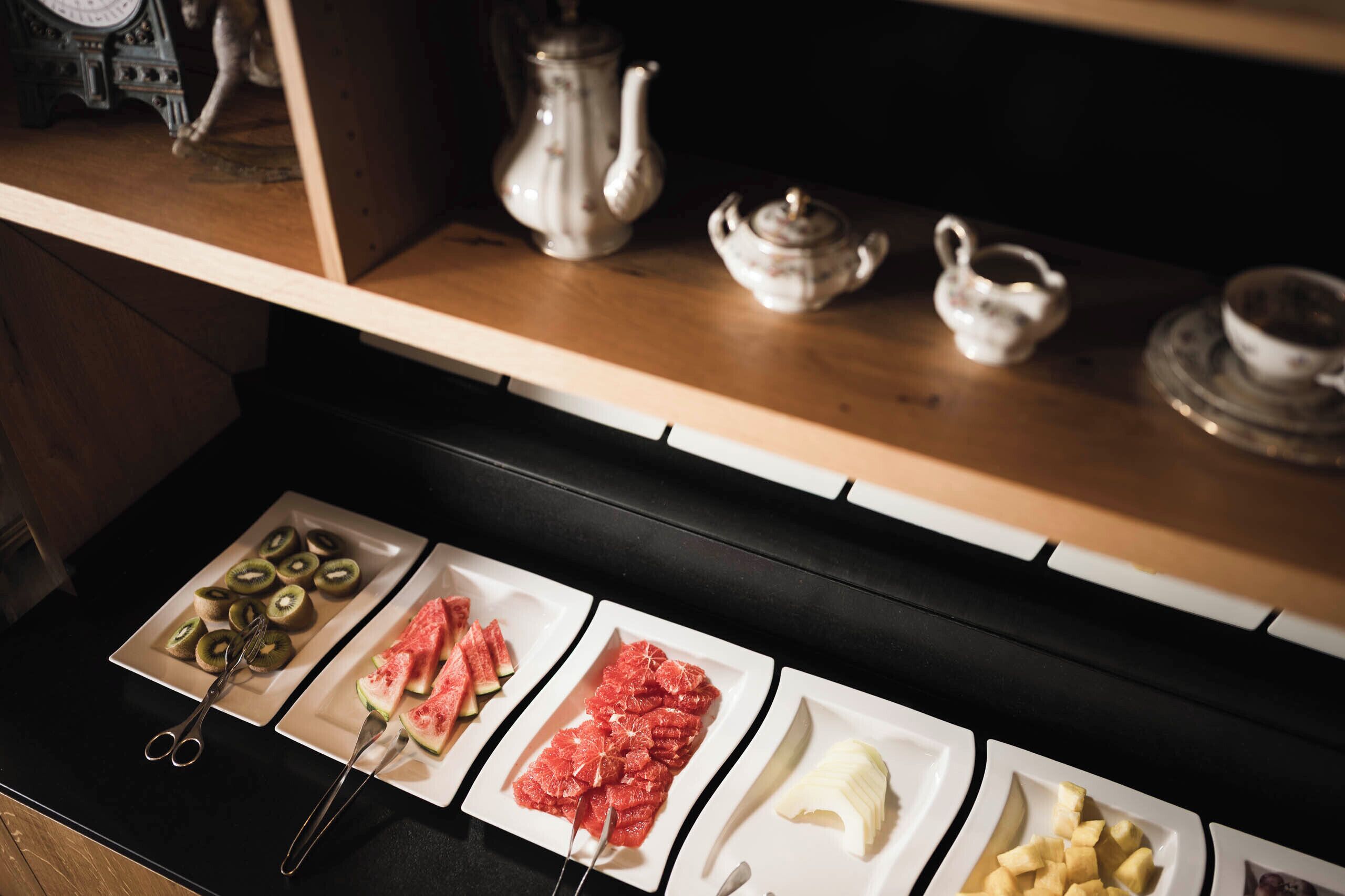 A kitchen counter with various food items and utensils.