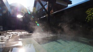 A swimming pool with a tiled deck and a clear blue water surface. - Tofuya Ryokan (Yonezawa)