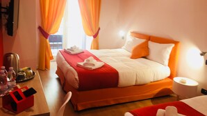 A hotel room with a bed, a desk with a telephone, and a window with curtains. - Grande Archivio Napoli 22 (Naples)