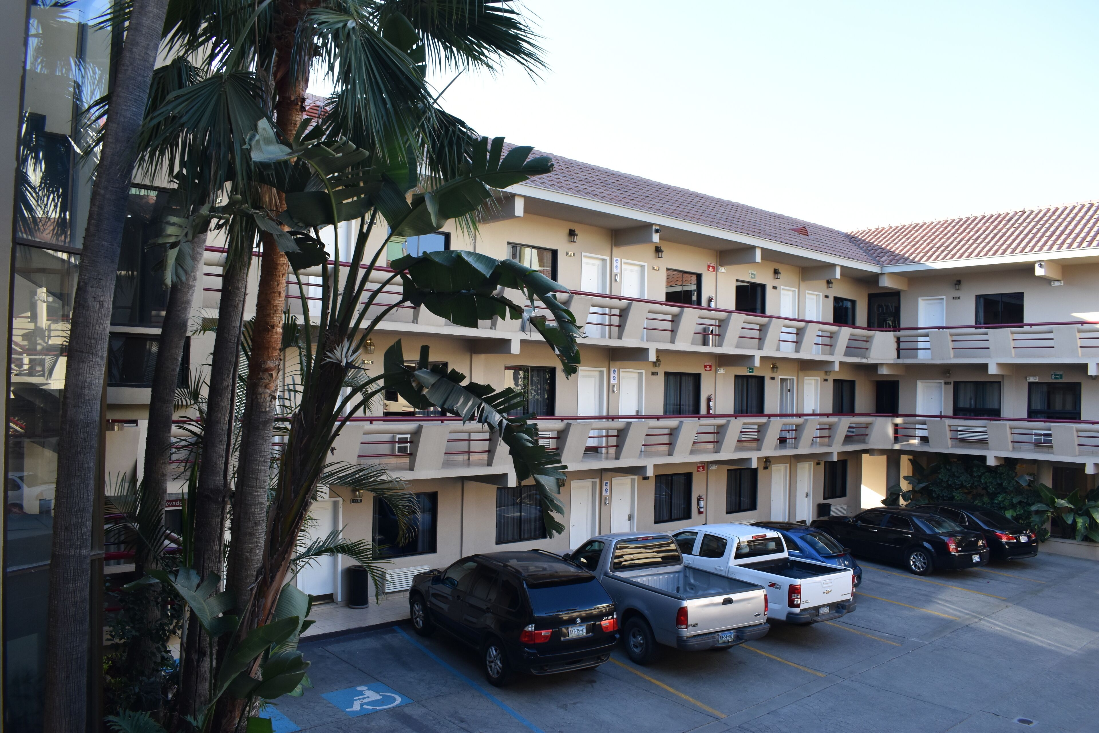 A multi-story hotel with a parking lot.