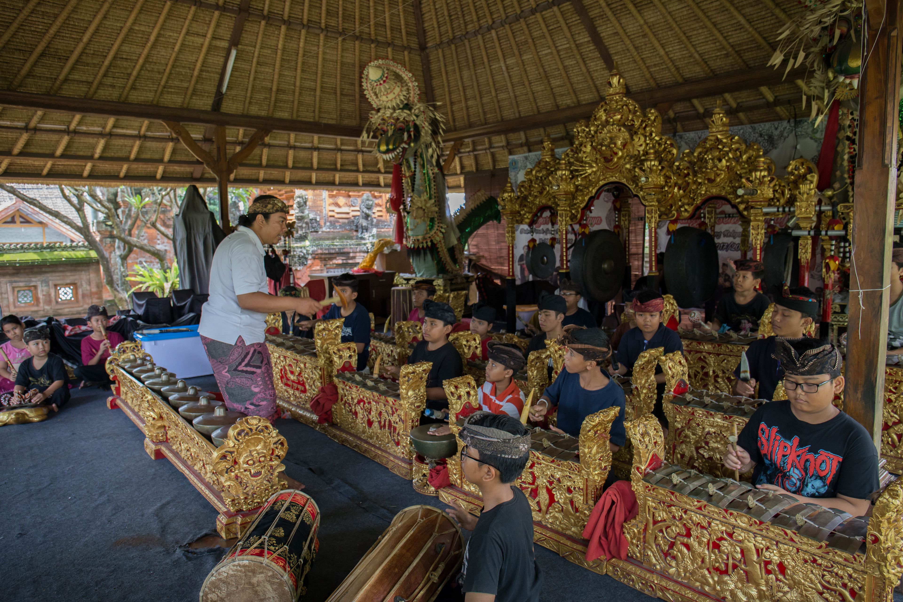 A traditional ceremony with ornate golden thrones and participants in ceremonial attire.