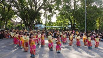 A group of dancers in colorful traditional costumes performing in an outdoor setting.