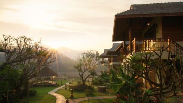 A traditional wooden building with a balcony, surrounded by a well-maintained garden and a winding path. - Pai Vimaan Resort (Pai)