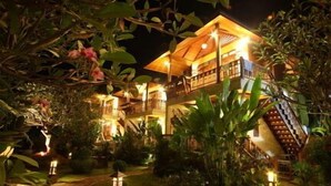 A two-story building with a balcony and a staircase leading to the upper level. - Pai Vimaan Resort (Pai)