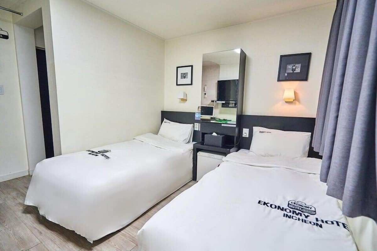 Economy Twin (Light Breakfast for 2 people, Free Access of Community Room - 1 hour per stay) | Premium bedding, desk, blackout drapes, iron/ironing board