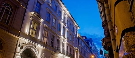 Un edificio histórico de arquitectura clásica, con ventanas de arco y detalles ornamentales.