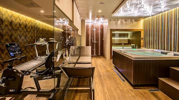 Experience a luxurious space for fitness and relaxation, featuring a heated hot tub, stationary bike, and treadmill.