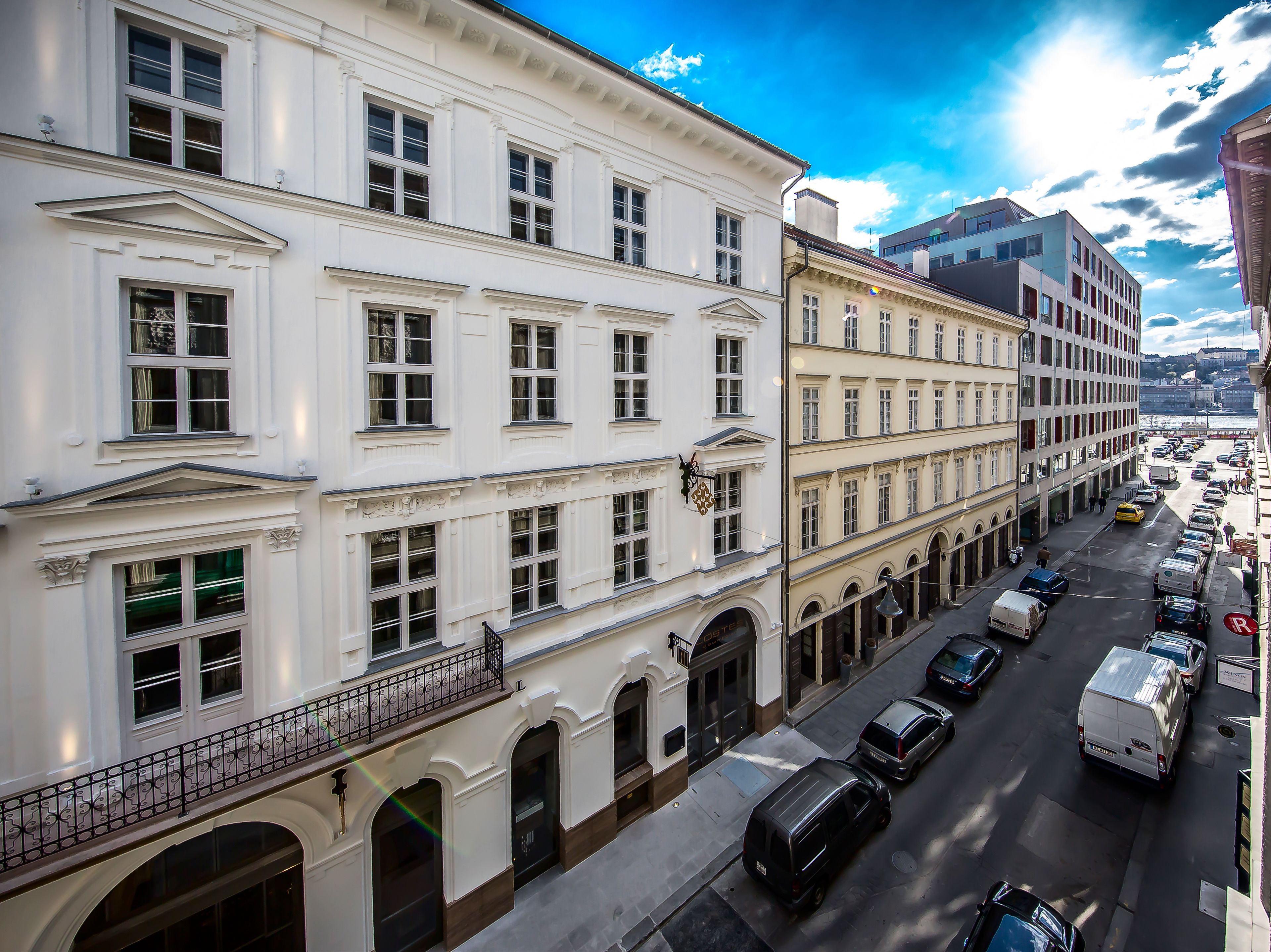 A multi-story building with a classical architectural style, featuring symmetrical windows and decorative moldings.