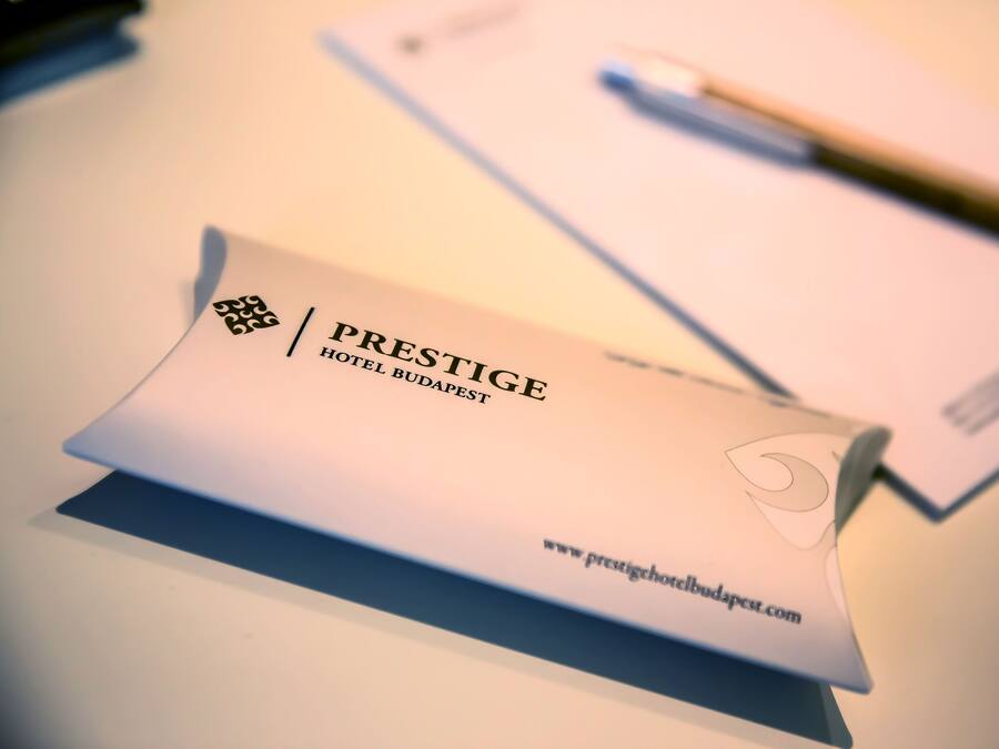 A brochure for Prestige Hotel Budapest with a visible website URL.