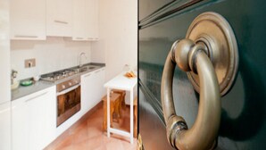 Una cocina con armarios blancos, una estufa y un lavabo.