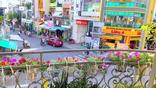 A busy street with various shops and a hotel named 'Lion 4' in the background. - Son Tung Hotel (Ho Chi Minh City)