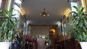 A hotel lobby with a chandelier, potted plants, and a reception desk. - Son Tung Hotel (Ho Chi Minh City)